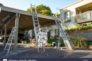 Workers Lean Ladders On A Carport While Preparing To Paint Picture Sample in Metal Carport Paint